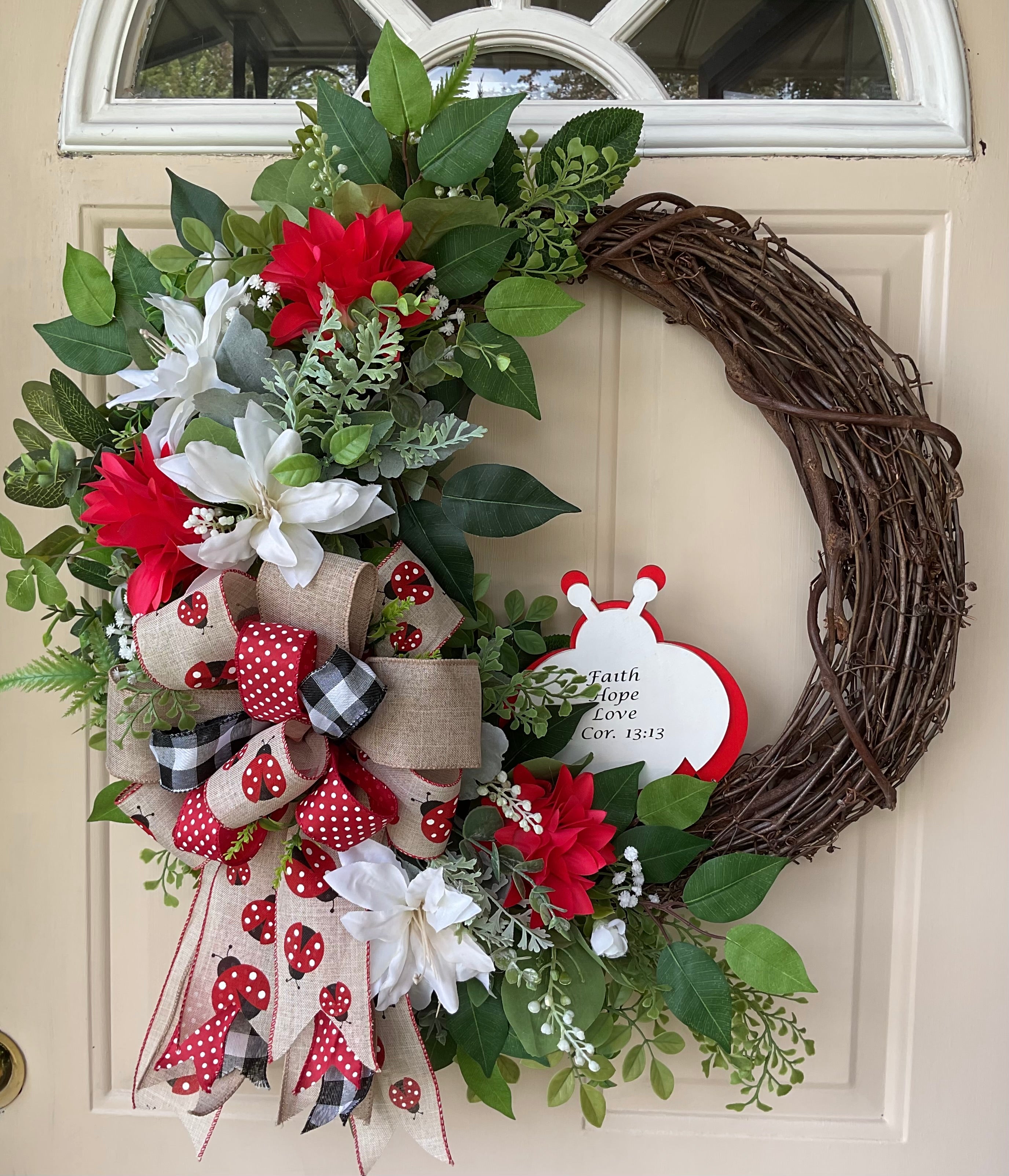 Red and White Floral Asymmetric Grapevine Wreath Accented with Ladybug Bow, lnfused with Bible Scripture.